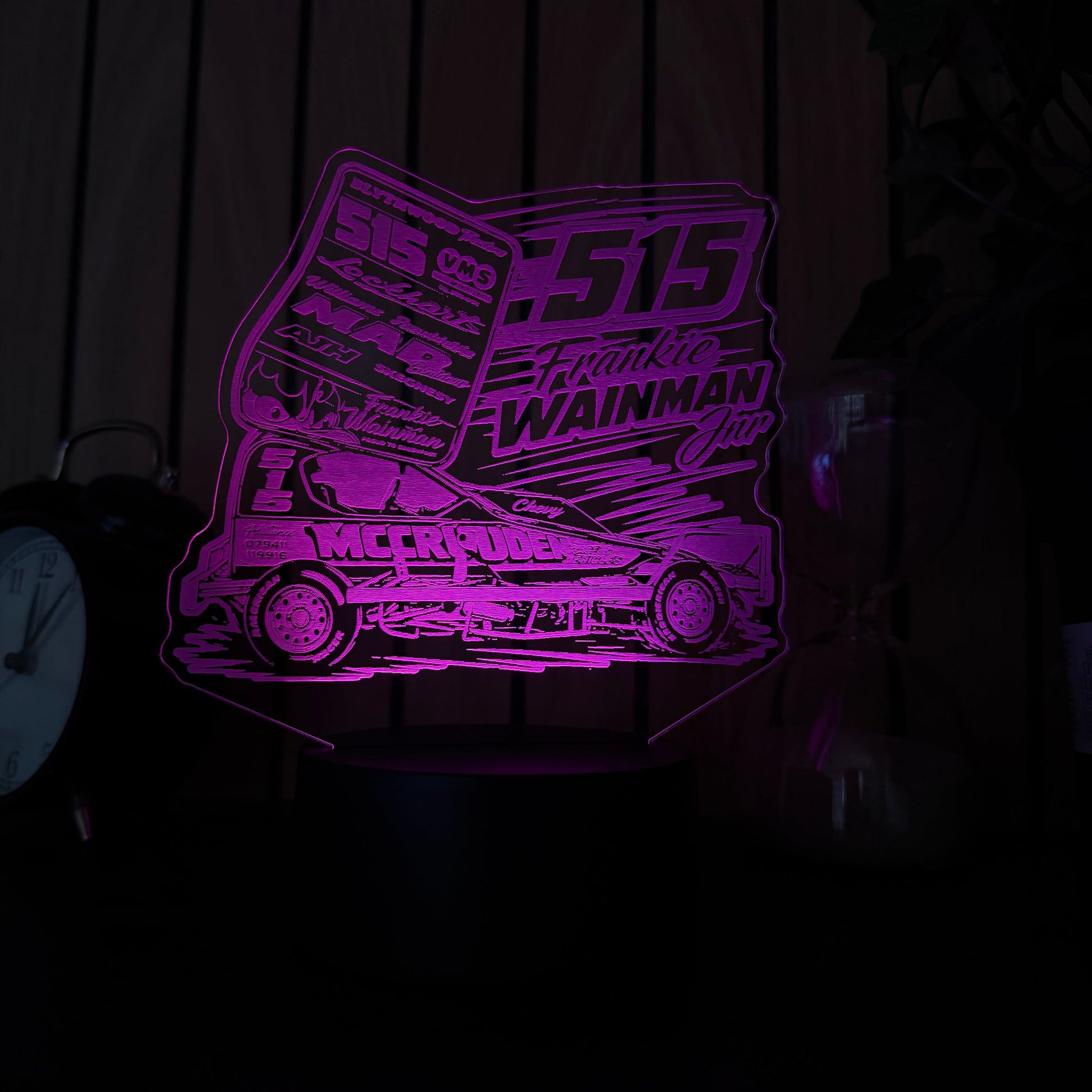 Purple laser cutout of a geometric design on a dark surface of 515 frankie wainmann jnr stockcar and banger racing merchandise and night light